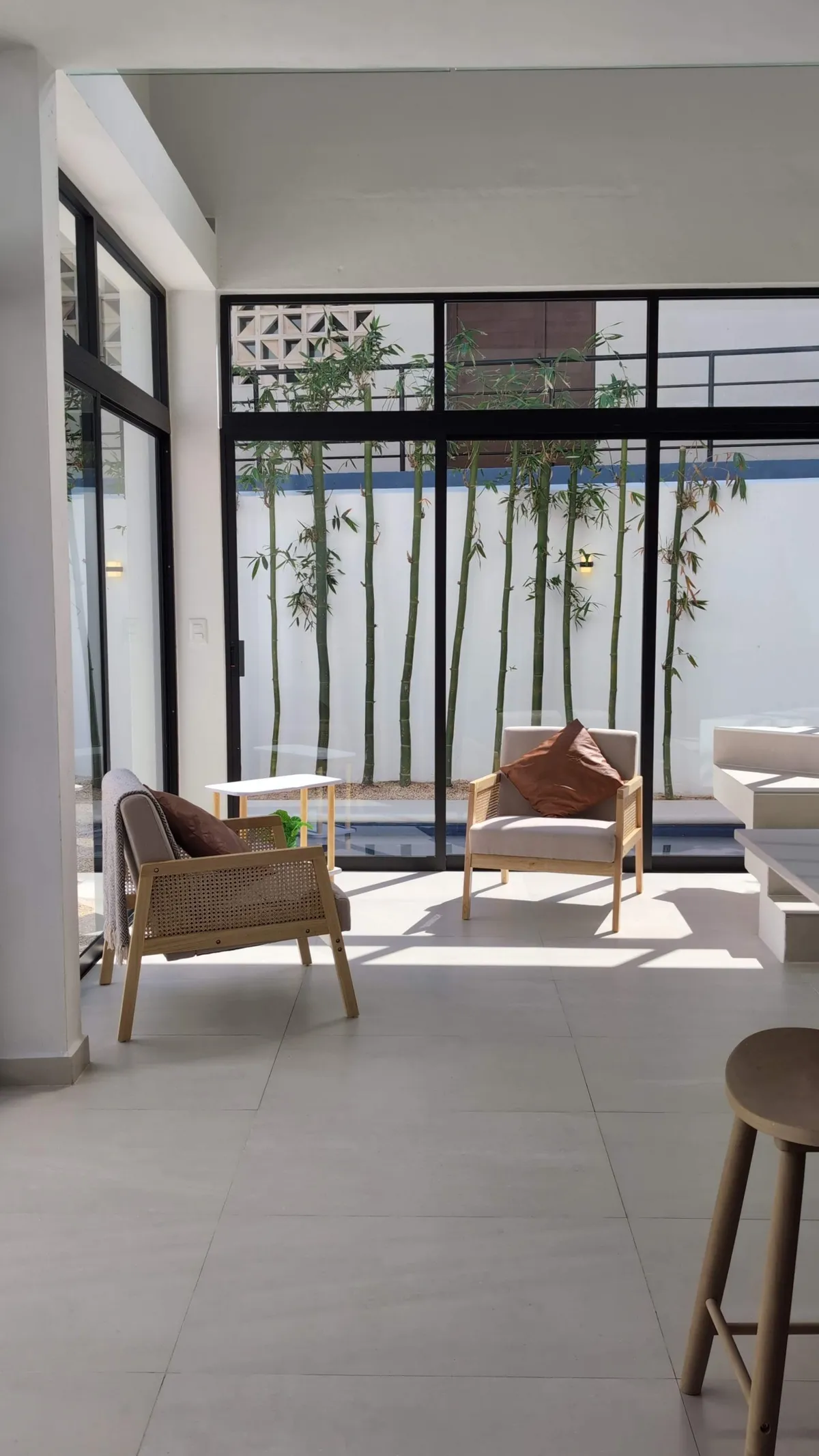 Open-plan living room with lounge chairs and views of the garden